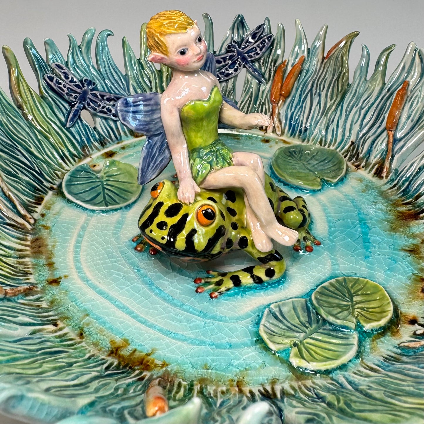 03 Fairy riding a fire bellied toad in a pond - White Stoneware