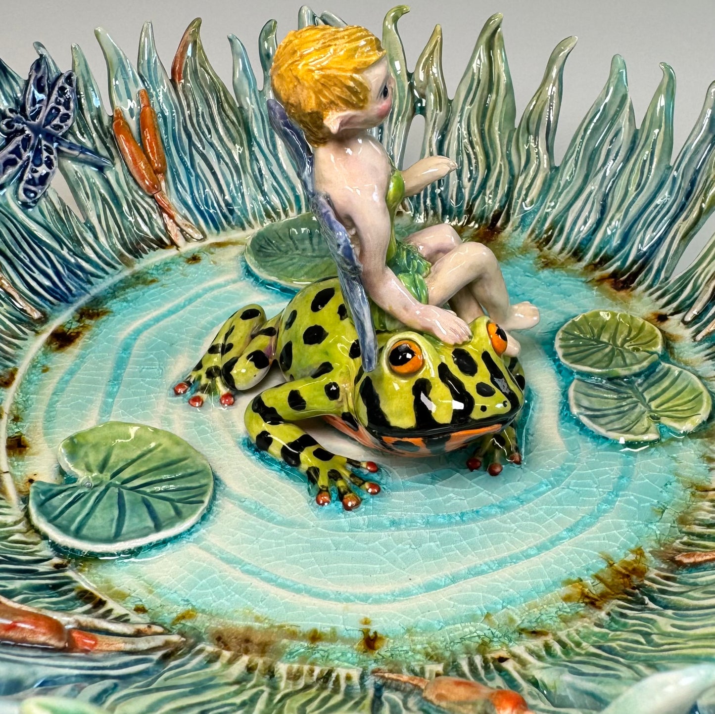 03 Fairy riding a fire bellied toad in a pond - White Stoneware