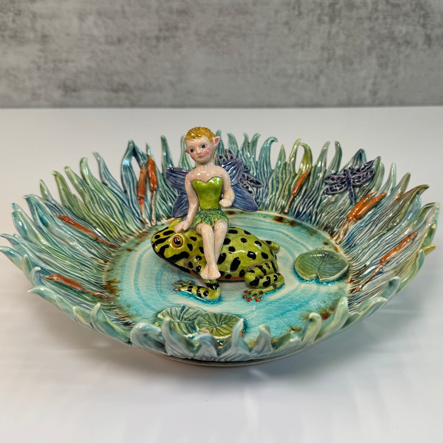 03 Fairy riding a fire bellied toad in a pond - White Stoneware