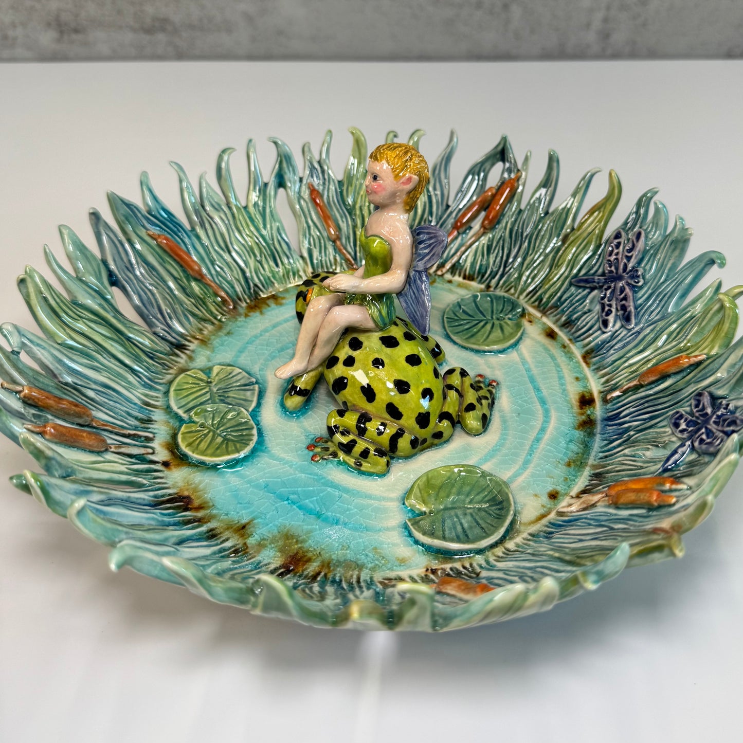 03 Fairy riding a fire bellied toad in a pond - White Stoneware